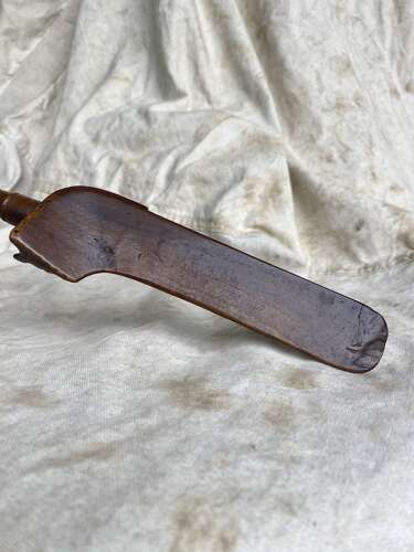 An antique early 19th century folk art fruitwood knitting sheath with apotropaic symbol