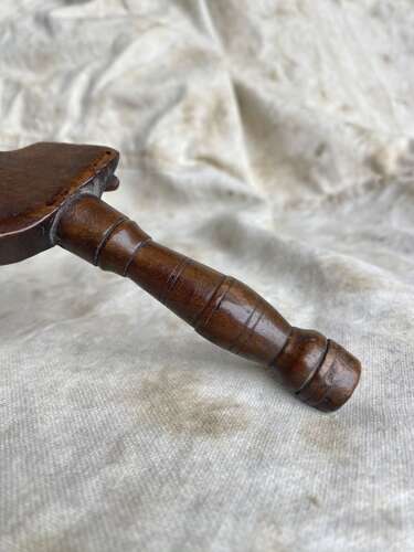 An antique early 19th century folk art fruitwood knitting sheath with apotropaic symbol
