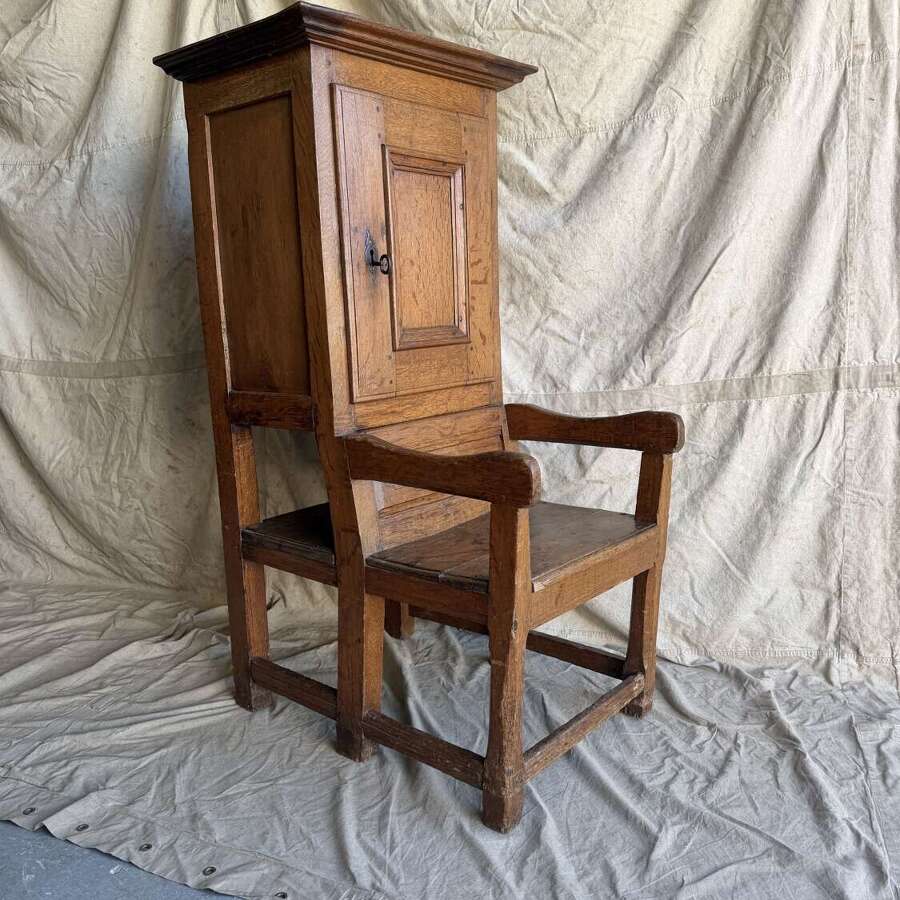 An early 19th century antique oak Porter's chair
