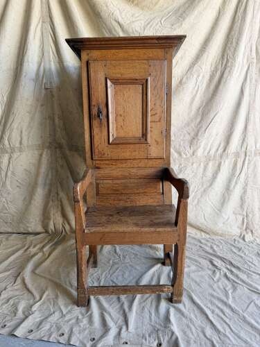 An early 19th century antique oak Porter's chair