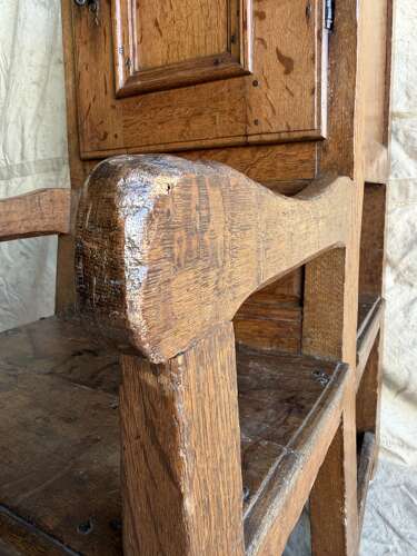 An early 19th century antique oak Porter's chair